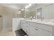 Bathroom featuring double sink vanity, stone tile shower, and recessed lights at 6281 Dry Tortugas Dr, Sarasota, FL 34241