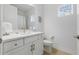 Bright bathroom with white vanity, unique stained glass window, and modern fixtures at 6281 Dry Tortugas Dr, Sarasota, FL 34241