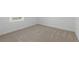Clean bedroom showcasing neutral-toned walls, plush carpeting, and a bright window for natural light and comfort at 6281 Dry Tortugas Dr, Sarasota, FL 34241