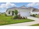 Charming one-story home featuring a well-manicured lawn and an attached two-car garage at 6281 Dry Tortugas Dr, Sarasota, FL 34241
