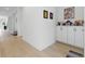 Spacious hallway featuring stylish light wood floors and neutral paint, complemented by elegant decor and furnishings at 6281 Dry Tortugas Dr, Sarasota, FL 34241