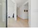 Bright and airy hallway showcasing modern light wood floors and neutral wall paint with stylish decor at 6281 Dry Tortugas Dr, Sarasota, FL 34241
