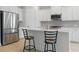 Modern kitchen featuring stainless steel appliances, quartz countertops, and breakfast bar at 6281 Dry Tortugas Dr, Sarasota, FL 34241