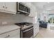 Gourmet kitchen with stainless steel range, gray subway tile backsplash, and quartz countertops at 6281 Dry Tortugas Dr, Sarasota, FL 34241