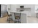 Modern kitchen featuring stainless steel appliances, quartz countertops, and breakfast bar at 6281 Dry Tortugas Dr, Sarasota, FL 34241