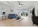 Bright living room with tray ceiling, neutral decor, and sliding glass doors to the patio at 6281 Dry Tortugas Dr, Sarasota, FL 34241