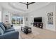 Bright living room with ceiling fan, recessed lights, neutral paint, and view to patio at 6281 Dry Tortugas Dr, Sarasota, FL 34241
