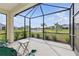Screened-in patio offering a serene view of the pond at 6281 Dry Tortugas Dr, Sarasota, FL 34241