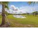 Scenic pond view framed by palm trees and blue skies at 6281 Dry Tortugas Dr, Sarasota, FL 34241