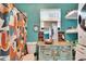 Unique bathroom with turquoise walls, colorful shower curtain, and custom vanity at 6409 N 23Rd St, Tampa, FL 33610