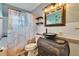Unique bathroom with a glass bowl sink and decorative shower curtain with hanging shelves at 6409 N 23Rd St, Tampa, FL 33610
