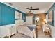 Stylish bedroom with blue accent wall, wood-paneled headboard, and white furniture at 6409 N 23Rd St, Tampa, FL 33610