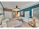 Well-lit bedroom with blue walls, wood-paneled headboard, and dual closets at 6409 N 23Rd St, Tampa, FL 33610
