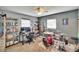 This bedroom features shelving, two windows and an entertainment space with a drumset at 6409 N 23Rd St, Tampa, FL 33610