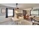 Cozy dining area featuring modern lighting, neutral tones and views into the living space at 6409 N 23Rd St, Tampa, FL 33610