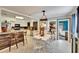 Dining room with bright white table and ladder-style chandelier at 6409 N 23Rd St, Tampa, FL 33610