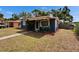 Cozy blue single-story home with a covered porch and neatly landscaped front yard at 6409 N 23Rd St, Tampa, FL 33610
