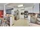 Modern kitchen with white cabinets, stainless steel appliances, and granite countertops at 6409 N 23Rd St, Tampa, FL 33610