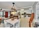 Open concept dining and kitchen area with white cabinetry and rustic wood accents at 6409 N 23Rd St, Tampa, FL 33610