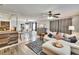 Open concept living and dining area featuring wood floors and a ceiling fan at 6409 N 23Rd St, Tampa, FL 33610