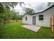 A cozy backyard patio featuring lush green grass and a privacy fence at 6504 N 13Th St, Tampa, FL 33604