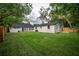 A sprawling backyard showcases a well-manicured lawn and mature trees at 6504 N 13Th St, Tampa, FL 33604