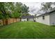 Private fenced yard with lush grass and updated home exteriors at 6504 N 13Th St, Tampa, FL 33604