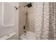 Bathroom featuring modern shower head and tiled walls, with bathtub and shower curtain at 6504 N 13Th St, Tampa, FL 33604