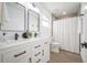 Bright bathroom features double sinks, sleek fixtures, and modern shower at 6504 N 13Th St, Tampa, FL 33604