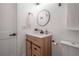 Bathroom features a modern vanity with a round mirror and stylish fixtures at 6504 N 13Th St, Tampa, FL 33604