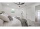 Bright bedroom features a ceiling fan, a decorative rug, and neutral decor at 6504 N 13Th St, Tampa, FL 33604