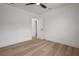 A minimalist bedroom features wood floors and an open doorway at 6504 N 13Th St, Tampa, FL 33604