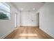 A bright bedroom features wood floors and a doorway to the exterior at 6504 N 13Th St, Tampa, FL 33604