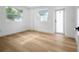 A bright bedroom features wood floors, white trim and windows at 6504 N 13Th St, Tampa, FL 33604