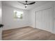 A bright bedroom features a ceiling fan, wood floors and a closet at 6504 N 13Th St, Tampa, FL 33604