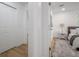 Hallway view leading to a bedroom with an accent rug and a comfortable bed at 6504 N 13Th St, Tampa, FL 33604