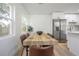 Dining area featuring a rustic table with modern chairs and natural light at 6504 N 13Th St, Tampa, FL 33604