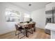 Bright dining room with modern table, chairs, and plenty of natural light from large windows at 6504 N 13Th St, Tampa, FL 33604