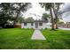 Beautifully landscaped home with mature trees and a lush lawn at 6504 N 13Th St, Tampa, FL 33604
