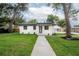 Charming home featuring a manicured lawn and fresh exterior paint at 6504 N 13Th St, Tampa, FL 33604