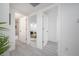 Hallway leads to a bathroom and living area with neutral decor at 6504 N 13Th St, Tampa, FL 33604