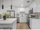 Contemporary kitchen with white cabinetry and stainless steel appliances at 6504 N 13Th St, Tampa, FL 33604