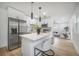 Bright kitchen with white cabinetry, stainless steel appliances, and an island with bar seating at 6504 N 13Th St, Tampa, FL 33604