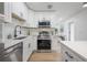Well-lit kitchen featuring white cabinets, stainless steel appliances and a modern design at 6504 N 13Th St, Tampa, FL 33604