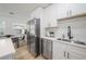 Kitchen with stainless steel refrigerator, modern countertops, and white cabinetry at 6504 N 13Th St, Tampa, FL 33604