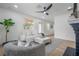 Spacious living room with a decorative fireplace and sleek ceiling fan at 6504 N 13Th St, Tampa, FL 33604