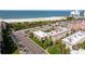 Aerial view of condo complex close to the beach with palm trees and parking at 6700 Sunset Way # 303, St Pete Beach, FL 33706