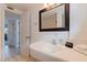 Bright bathroom featuring modern sink, mirror, and stylish black hardware at 6700 Sunset Way # 303, St Pete Beach, FL 33706
