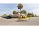 Condominium building with palm trees and ample parking near the beach at 6700 Sunset Way # 303, St Pete Beach, FL 33706