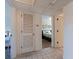 Hallway leading to a bedroom, with tile flooring and a closet for extra storage at 6700 Sunset Way # 303, St Pete Beach, FL 33706